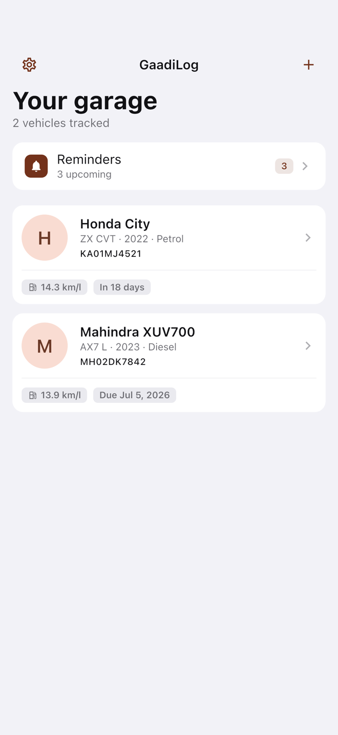 The vehicles list — a stack of saved cars with photos and registration numbers.